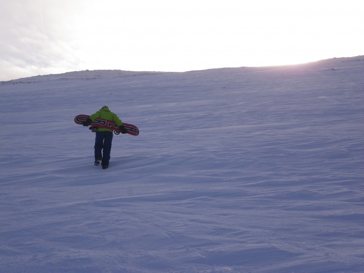 A snowboarder heads up Marquis Well on Cairngorm