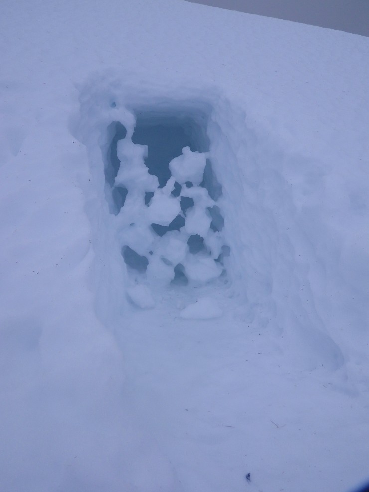 Interesting thaw sculptures over a snow hole entrance